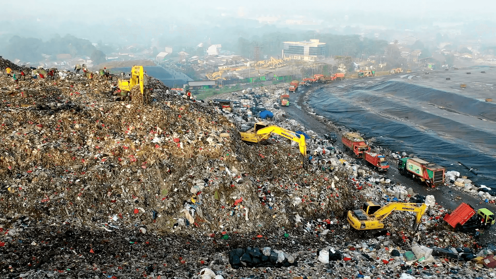 Landfill site with excavators processing organic waste